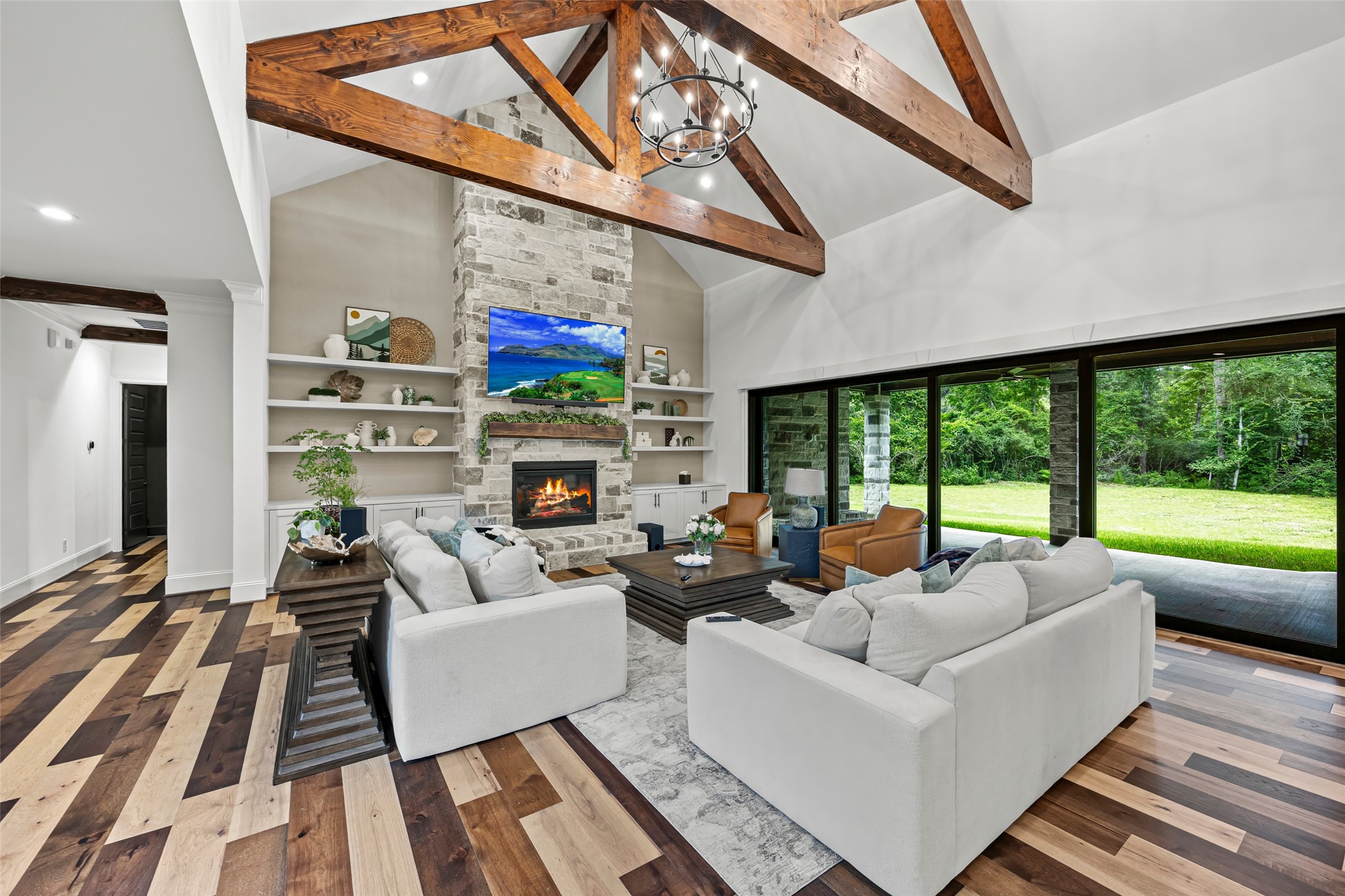 19314 Chateau Ridge Court Tomball, TX 77377 - Photo 4 of 50 Luxurious open living space featuring a stone fireplace, soaring ceilings, and seamless indoor-outdoor flow.