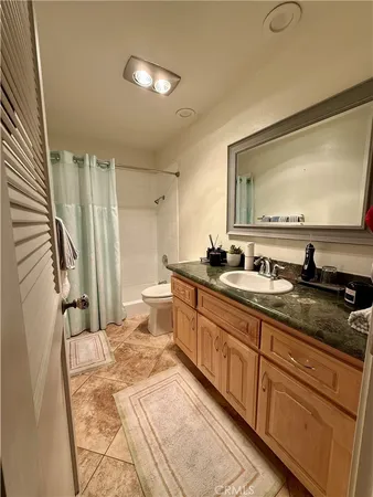 a spacious bathroom with a double vanity sink a mirror and a shower