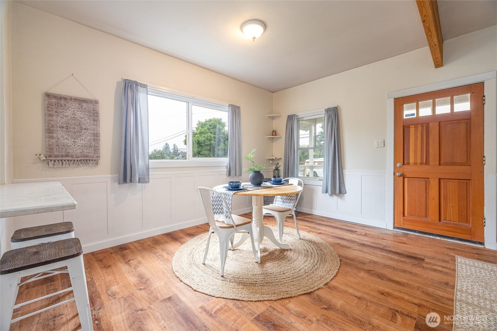 812 Sumas Avenue Sumas, WA 98295 - Photo 9 of 24 a dining room with wooden floor a chandelier a wooden table and chairs