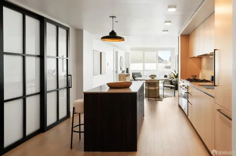a kitchen with stainless steel appliances granite countertop a refrigerator and a stove top oven