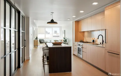 a kitchen with stainless steel appliances a sink and a refrigerator