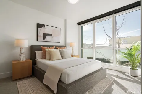 a bedroom with a large bed and a large window