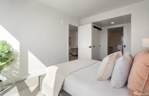 a bedroom with a bed and a large mirror