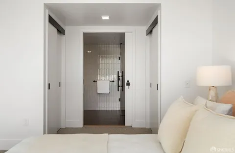 a bedroom with a bed and a lamp