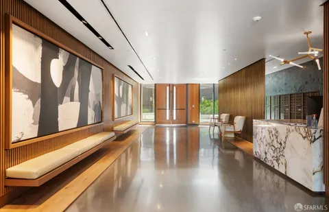 a living room with a large window and furniture