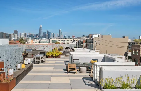 a view of a dining room with furniture and a floor to ceiling window