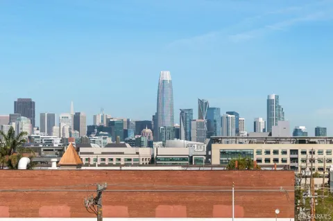 a front view of multi story residential apartment building with yard and green space