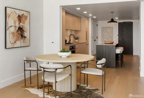 a view of a dining room with furniture and a chandelier