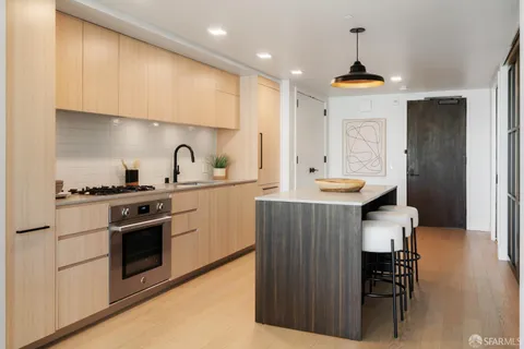 a kitchen with a sink cabinets and wooden floor