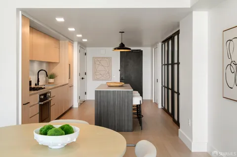 a kitchen with stainless steel appliances granite countertop a sink a stove and a refrigerator