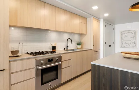 a kitchen with stainless steel appliances a stove and a refrigerator