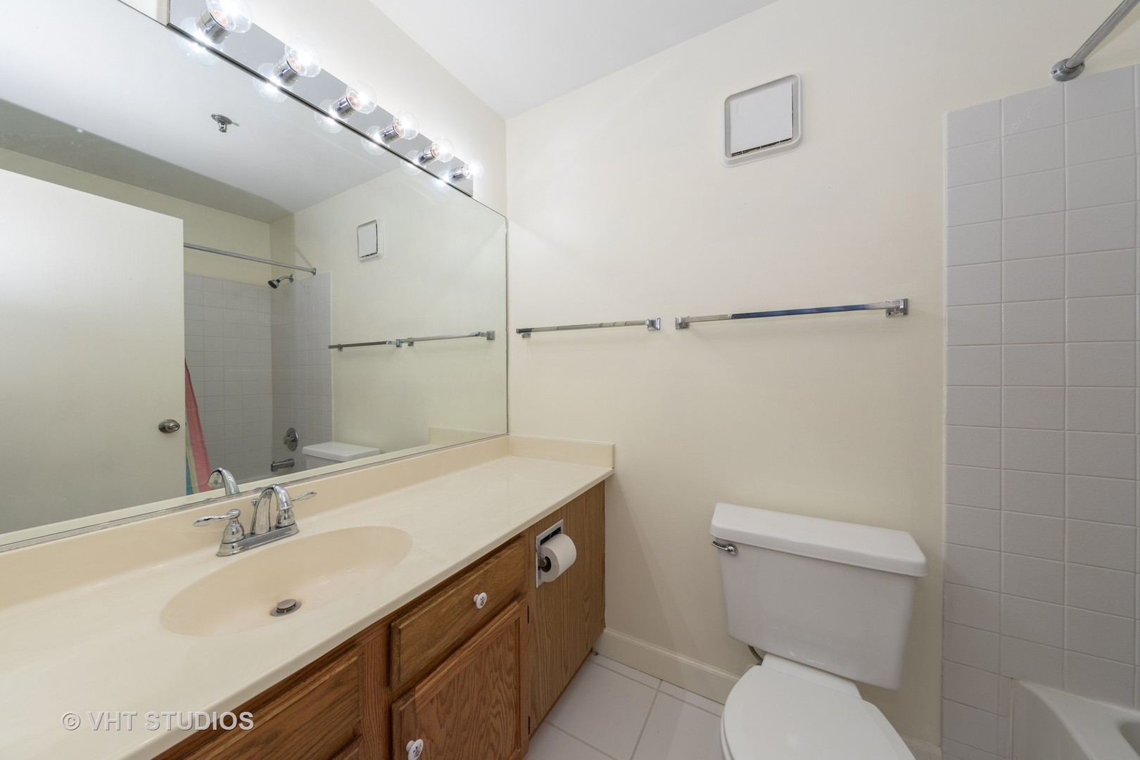 3275 Kirchoff Road, Unit 231 Rolling Meadows, IL 60008 - Photo 10 of 12 a bathroom with a toilet a sink a mirror and vanity
