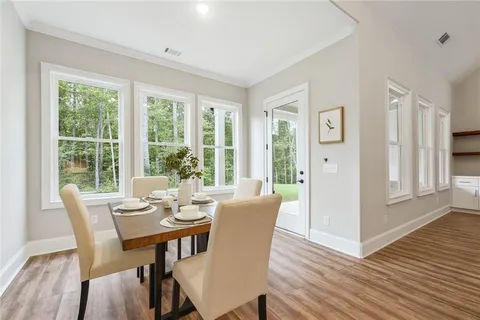 a view of a dining room with furniture window and wooden floor