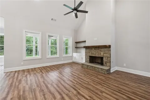 wooden floor fireplace and natural light in empty room
