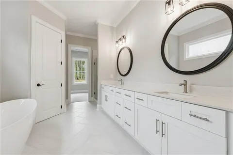 a bathroom with 2 sink and a mirror