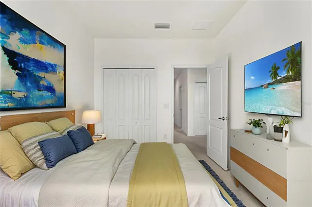 a bedroom with a bed and a flat screen tv