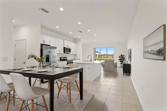 a kitchen with a table and chairs in it