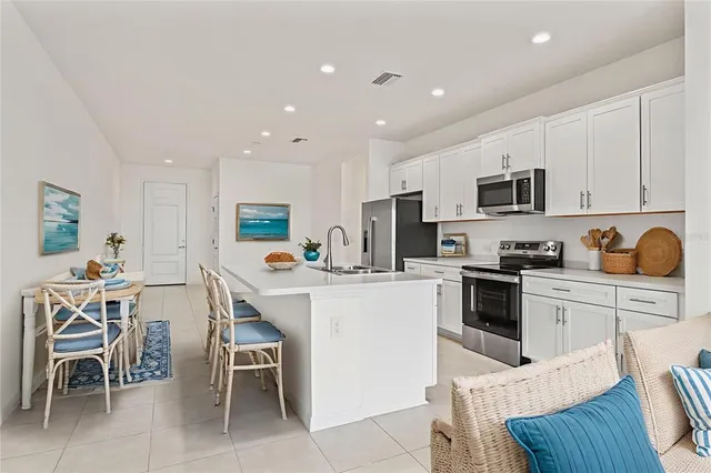 a kitchen with a sink a microwave a counter top space and cabinets
