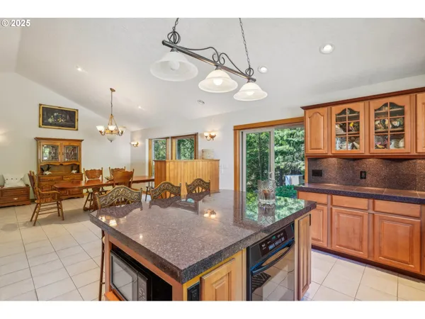 a kitchen with a counter space wooden floor and stainless steel appliances