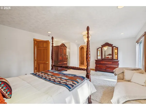 a living room with furniture a flat screen tv and a window