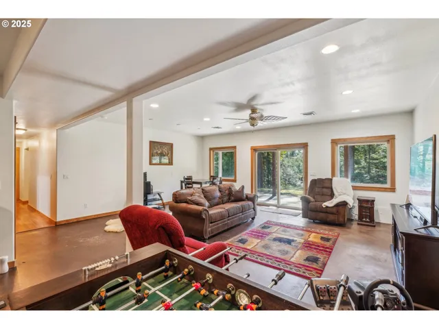 a living room with furniture a flat screen tv and a large window