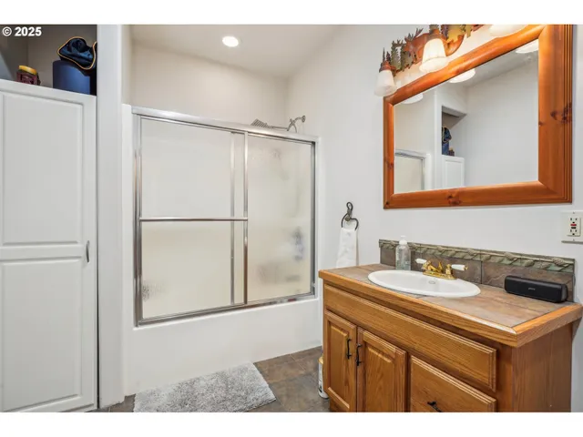 a bathroom with a sink vanity and a mirror