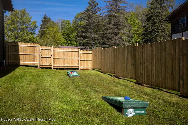 a view of a backyard with wooden fence