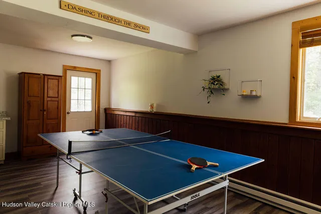 a room with pool table and windows