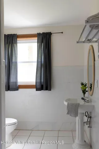 a bathroom with a sink a toilet and tub