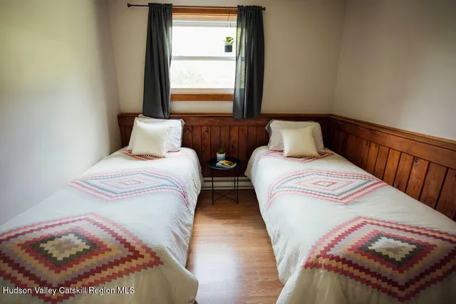 a bedroom with two beds and a window