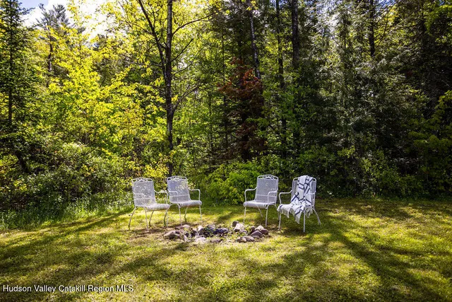 a wooden bench sitting in a backyard