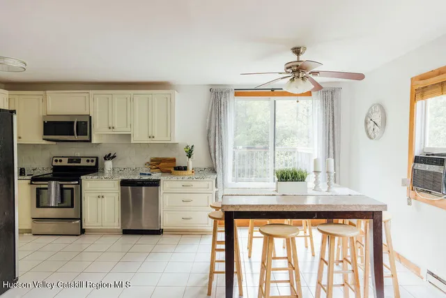 a kitchen with stainless steel appliances a stove sink and microwave