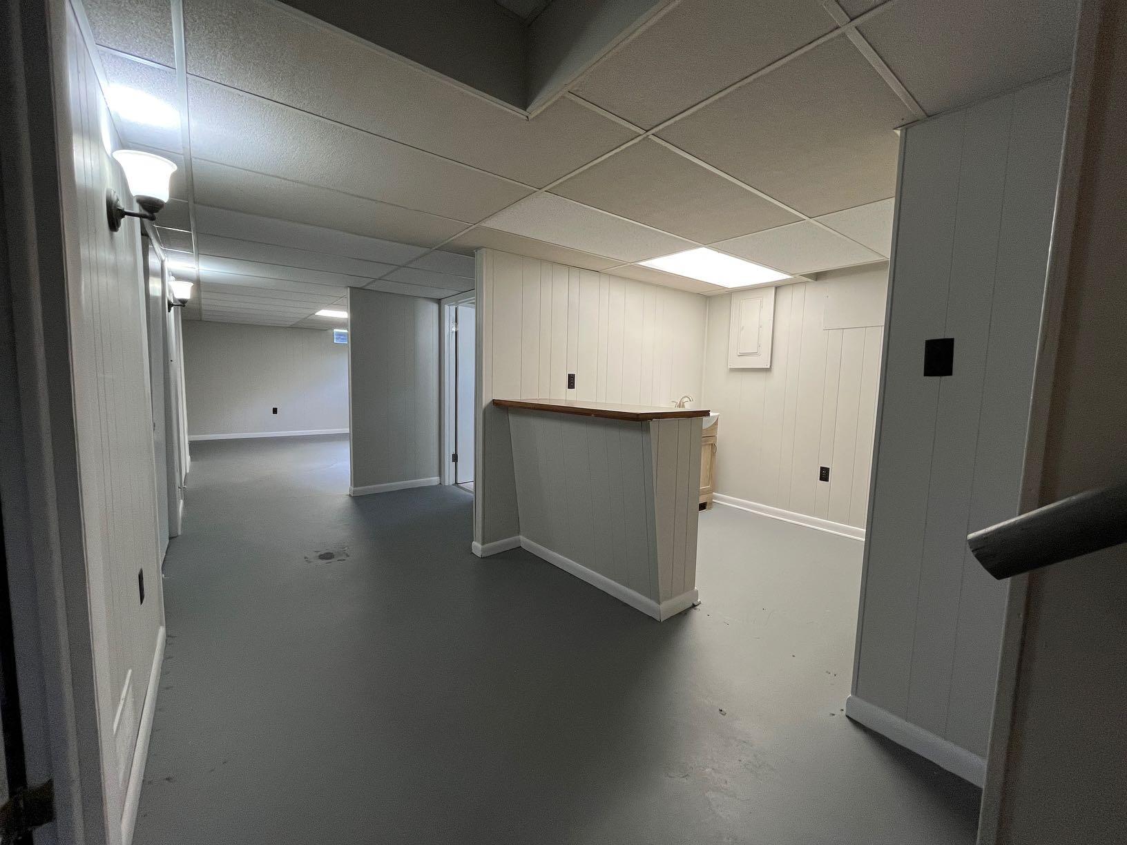 2548 Beverly Boulevard Southwest Roanoke, VA 24015 - Photo 12 of 17 an empty room with wooden floor and a bathroom
