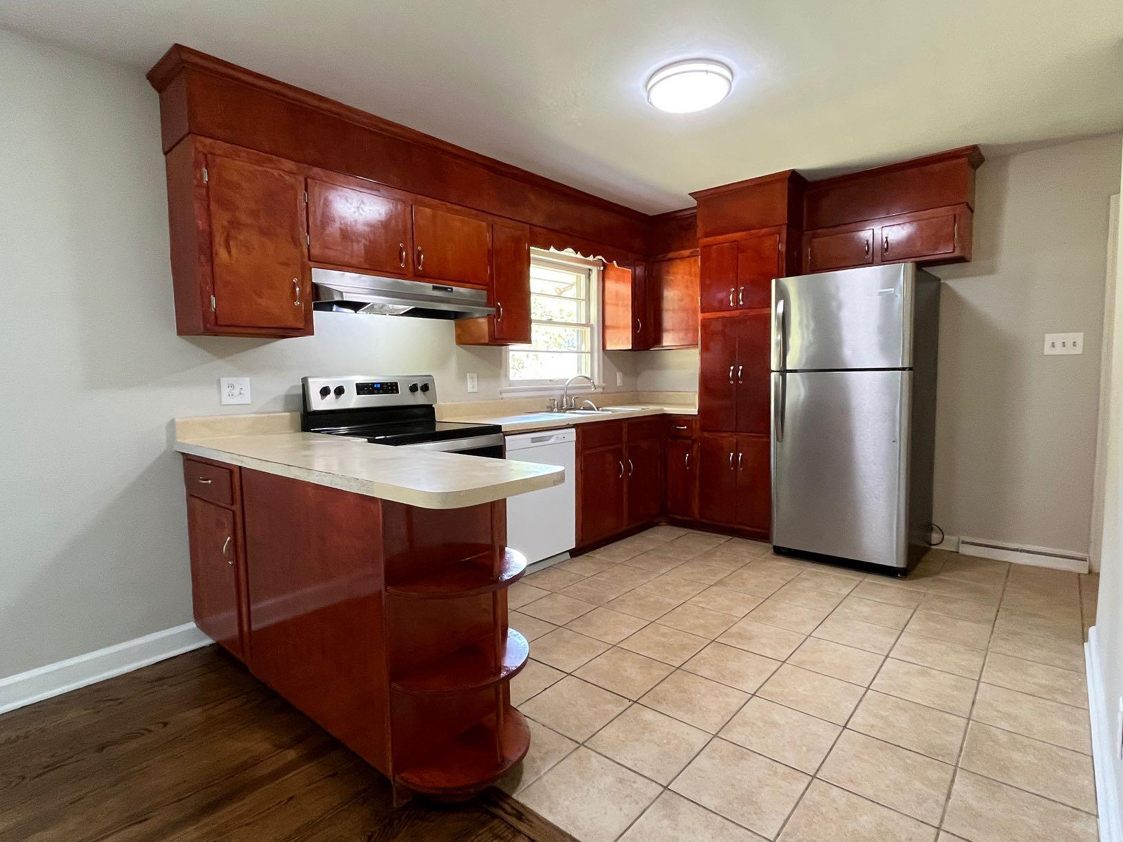 2548 Beverly Boulevard Southwest Roanoke, VA 24015 - Photo 3 of 17 a kitchen with stainless steel appliances granite countertop a stove a refrigerator and a sink