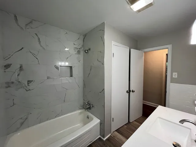 a bathroom with a bathtub and shower