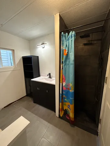 a bathroom with a double vanity sink and mirror