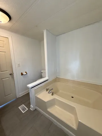 a bathroom with a tub and shower