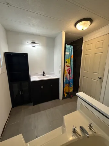 a bathroom with a sink and mirror