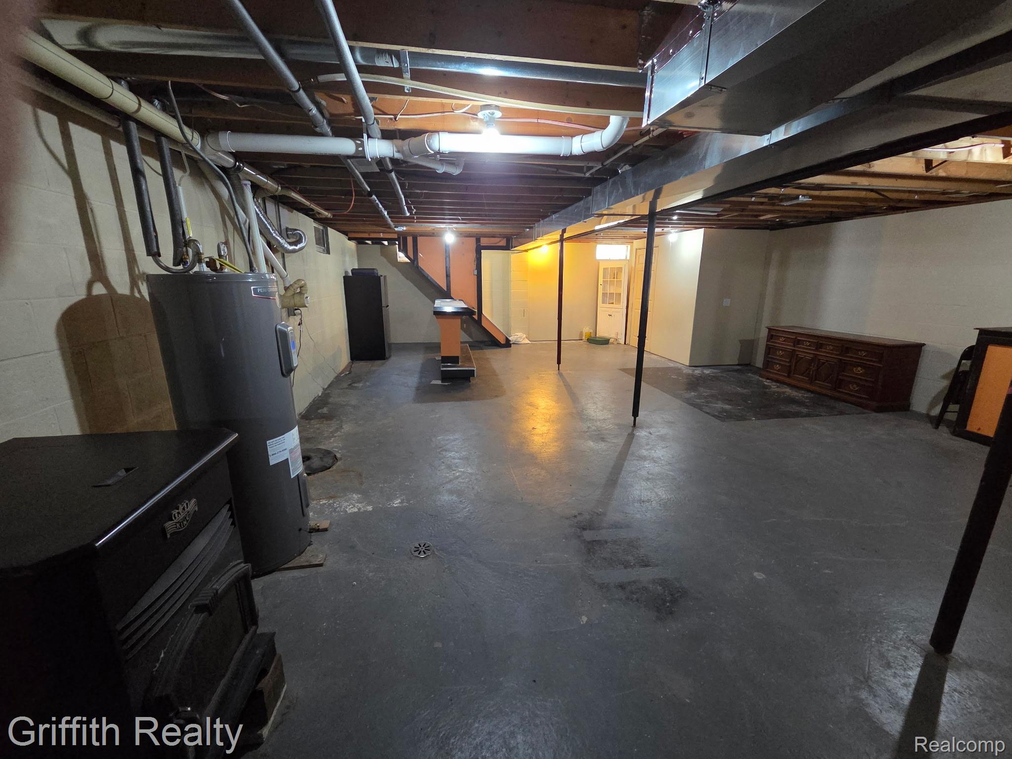 3148 Hogback Road Fowlerville, MI 48836 - Photo 65 of 75 Spacious unfinished basement with exposed ceiling beams and concrete flooring