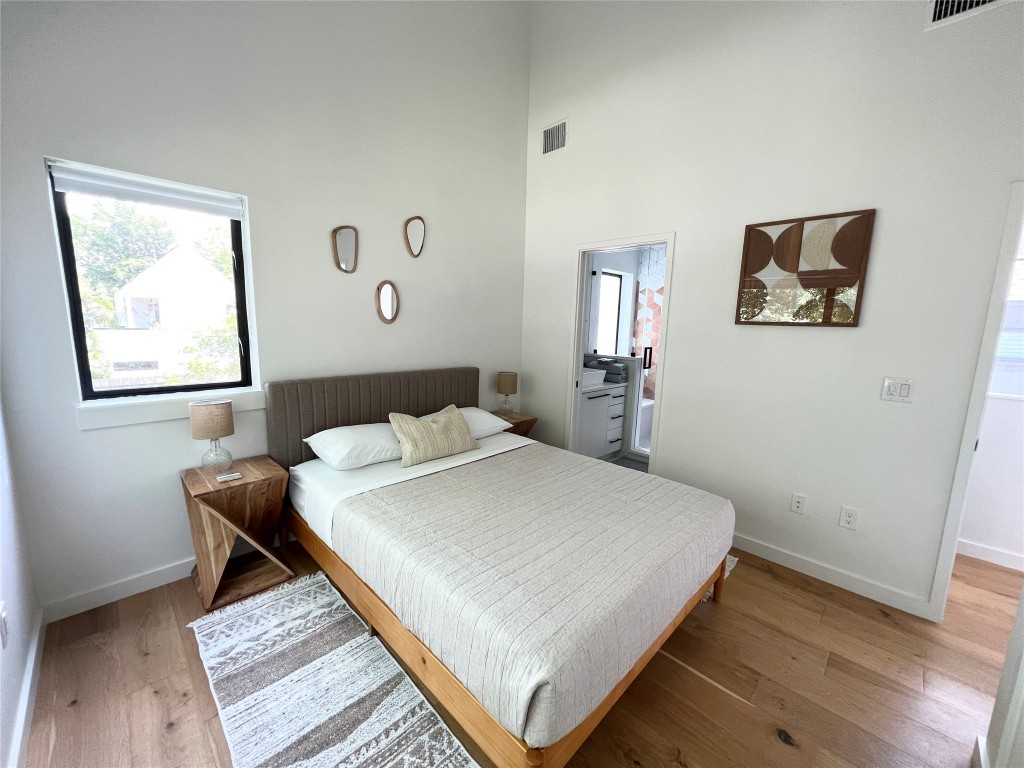 1100 Brass Street, Unit 2 Austin, TX 78702 - Photo 13 of 27 a bedroom with a bed and a table