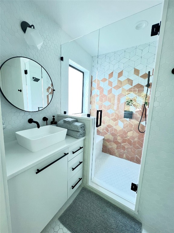 1100 Brass Street, Unit 2 Austin, TX 78702 - Photo 14 of 27 a bathroom with a sink a mirror and a shower