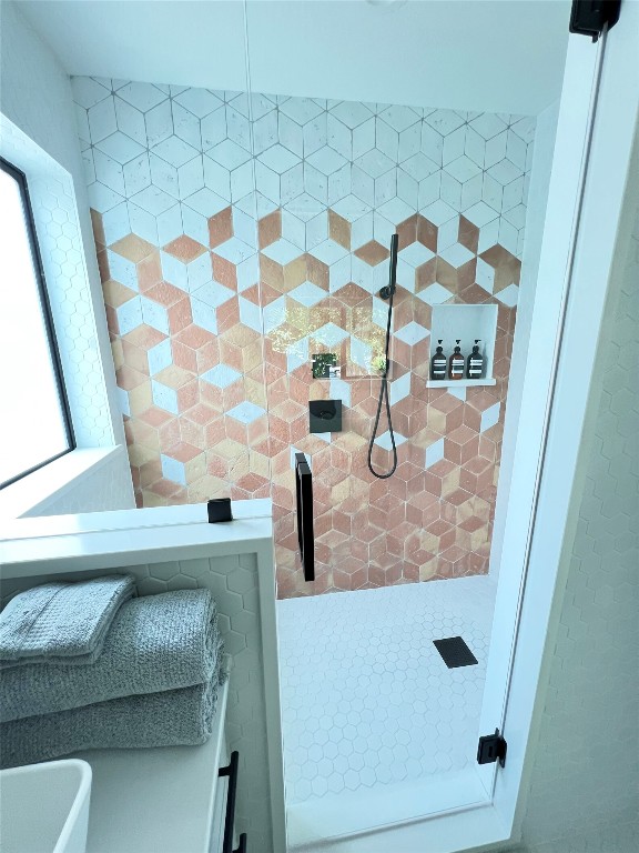 1100 Brass Street, Unit 2 Austin, TX 78702 - Photo 15 of 27 a bathroom with a granite countertop sink a mirror and shower