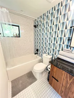 a bathroom with a toilet a sink and a bathtub
