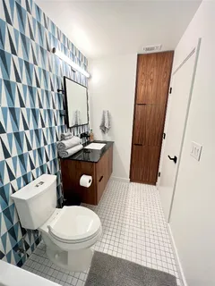 a bathroom with a toilet a sink and a mirror