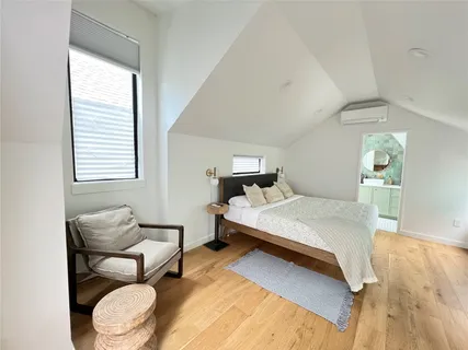 a bedroom with a bed and window