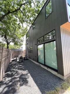a backyard of a house with table and chairs