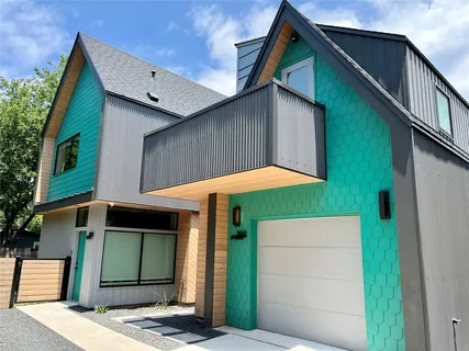 a view of a house with a yard and wooden fence