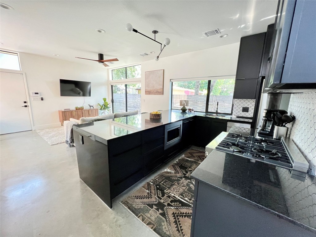 1100 Brass Street, Unit 2 Austin, TX 78702 - Photo 5 of 27 a large kitchen with stainless steel appliances granite countertop a sink stove and refrigerator