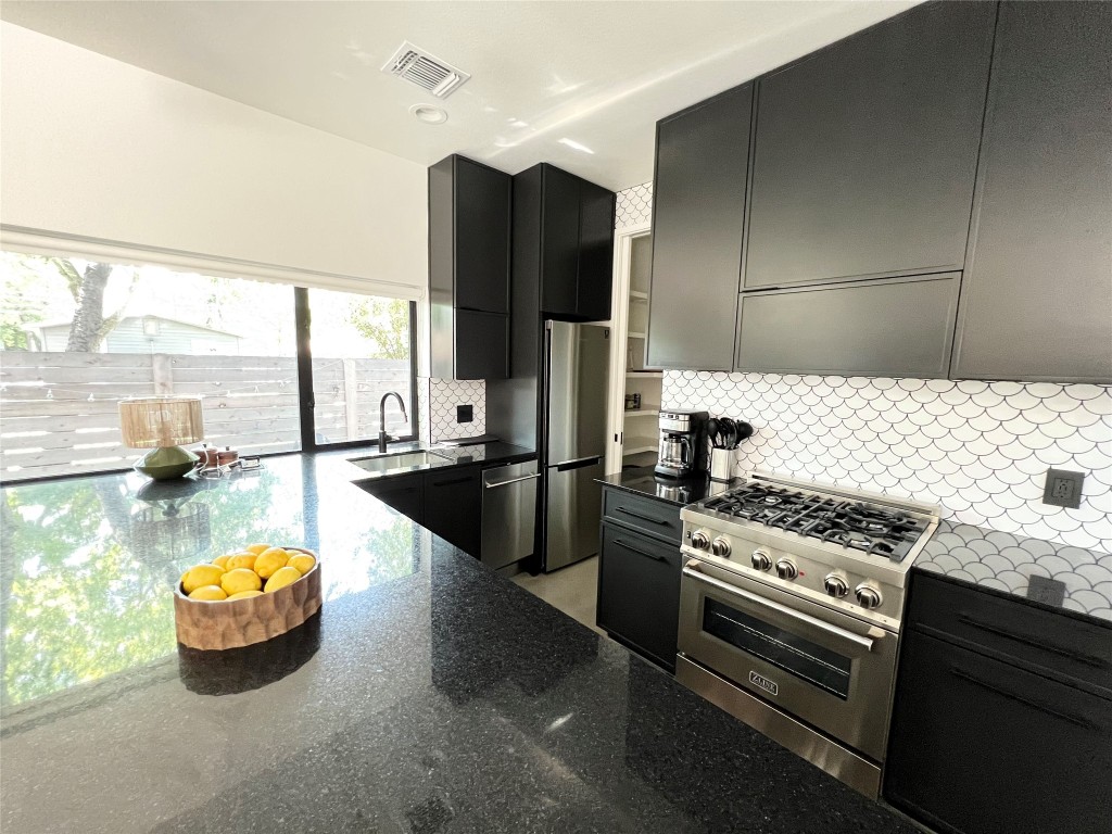 1100 Brass Street, Unit 2 Austin, TX 78702 - Photo 6 of 27 a kitchen with a stove and a refrigerator