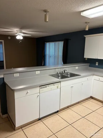 a kitchen with granite countertop a sink and cabinets